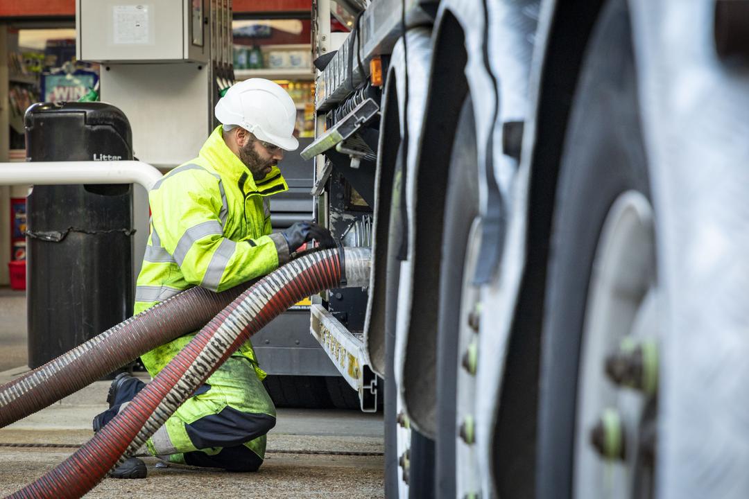 RAF Logistics Driver refuels Lorry with petrol pump..